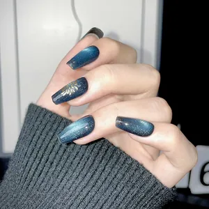 Blue cat eye press-on nails in long coffin shape with golden floral art patterns