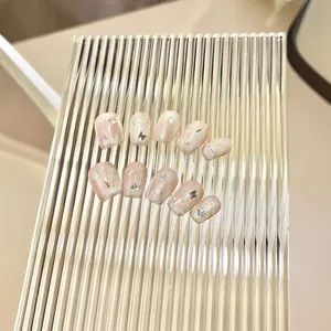 Handmade nude pink cat eye press-on nails with glitter butterfly charms on 10pc set
