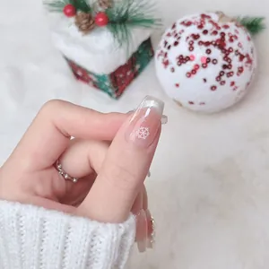 Handmade Christmas press-on nails with silver glitter French tip and white snowflake design