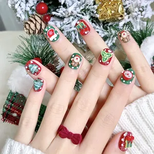 Handmade Christmas press-on nails featuring 3D Santa, reindeer, and tree designs