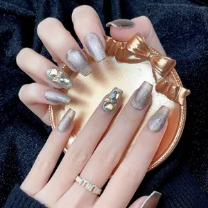 Handmade silver glitter press-on nails with luxury gold rhinestones in trapezoid shape