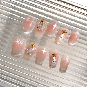 Detail of press-on nails featuring cat eye effect, snowflakes, and pearl decorations
