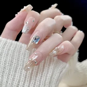 Handcrafted luxury press-on nails with silver glitter, pearls, and large square rhinestones