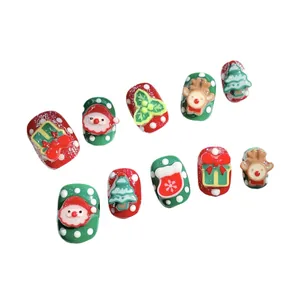3D Christmas press-on nails featuring Santa, reindeer, and tree designs on red and green