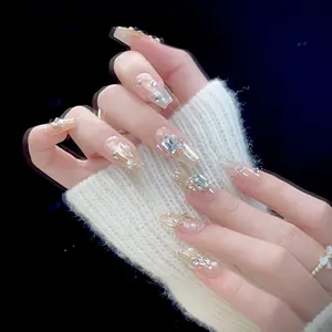 Handmade long coffin press-on nails in nude pink with glitter, rhinestones and pearls