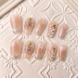 Handmade Christmas press-on nails with snowflakes, pearls, and star decorations