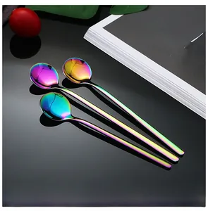 Detailed macro shot of three rainbow stainless steel spoons with a long handle design