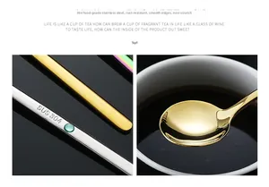 Macro detail of SUS 304 stamp and gold stainless steel coffee spoon in dark liquid