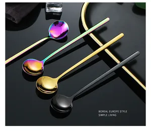 Detail of colorful and gold stainless steel long-handle round spoons for coffee and desserts