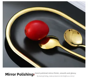 Macro shot of mirror-polished golden stainless steel spoon with sleek handle on plate