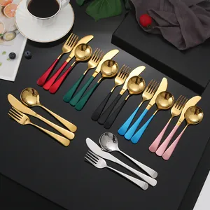 Set de couverts 3 pièces en acier inoxydable avec manches colorés sur fond sombre