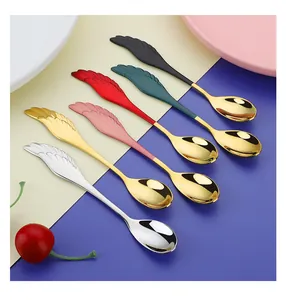 Detail of creative wing-shaped handles on colorful stainless steel dessert spoons