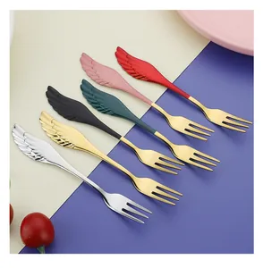 Close-up of creative wing-handle dessert forks in various colors including gold and silver