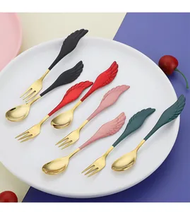 Detail of wing-shaped handles on stainless steel dessert spoons and forks in various colors