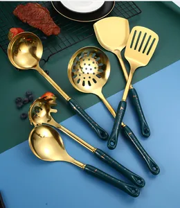 Close-up of golden stainless steel utensils with green marble handles in 6-piece set