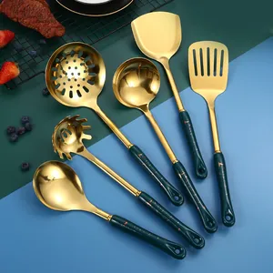 Modern gold stainless steel kitchen utensil set with dark green handles on color background