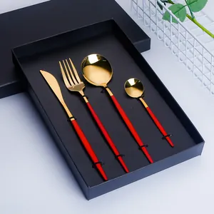 4-piece gold stainless steel flatware set with red handles in a premium gift box