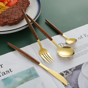 24-piece gold stainless steel cutlery set with elegant wood grain handles for dining