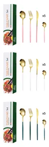 Golden stainless steel cutlery set with colorful handles in pink, white, and green