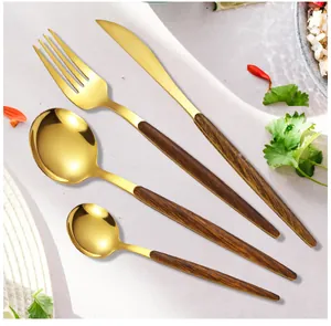 Close-up of gold stainless steel cutlery set with dark brown wood-patterned handles