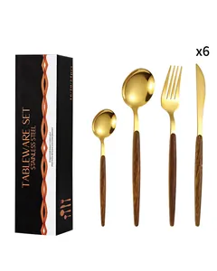 Detail of 24-piece golden stainless steel cutlery set with wood grain handles in black box