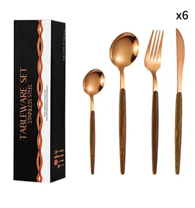 Detailed view of 4-piece rose gold cutlery set with wood-texture handles in a black gift box