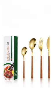 Detail of 24-piece gold stainless steel cutlery set with wood grain handles in a gift box