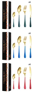 Close-up of 24pcs stainless steel cutlery set with gold finish and colorful handles