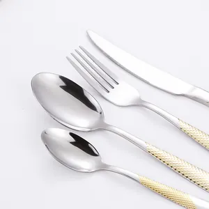 Polished silver stainless steel cutlery set with gold diamond texture handles