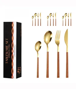 Detail of 16-piece gold stainless steel cutlery set with wooden handles in a black gift box