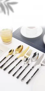 Macro view of stainless steel cutlery set with elegant marble textured handles