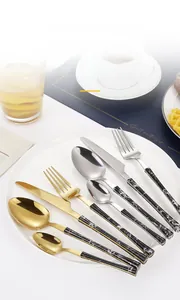 Detailed macro view of 430 stainless steel cutlery set with marble texture handles in a plate