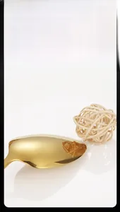 Detail of gold stainless steel dinner spoon with premium mirror polished finish