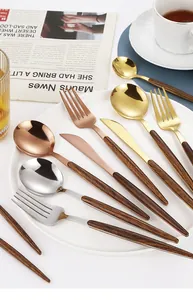 Detailed close-up of stainless steel cutlery with faux wood handles in multiple metallic finishes