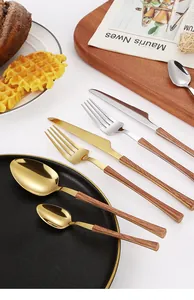 Detailed close-up of stainless steel cutlery with realistic wood grain handles in gold and silver