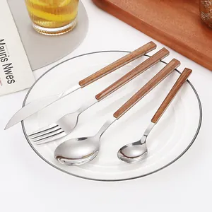 Modern 4-piece stainless steel cutlery set with elegant wood-grain handles on a white plate