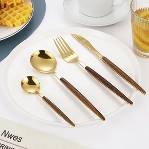 4-piece gold stainless steel cutlery set with brown wood-grain handles for steak dining