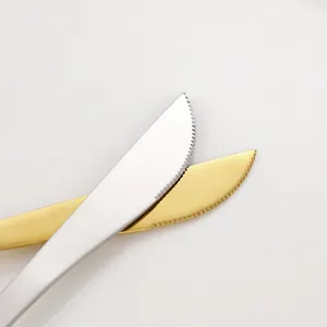 Polished stainless steel steak knives with serrated edges in gold and silver finish