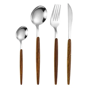 Vintage stainless steel cutlery set with wood grain handles including knife, fork and spoons
