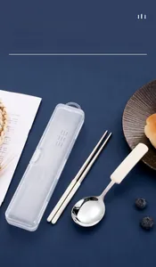 Close-up of portable 304 stainless steel cutlery set with cream handles and storage box