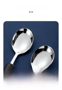 Close-up of polished 304 stainless steel spoons with smooth rounded edges and black handles