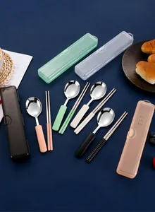 Detail view of portable stainless steel cutlery set with spoons and chopsticks in boxes