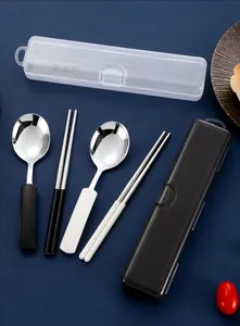 Close-up of portable 304 stainless steel chopsticks and spoons set in black and white