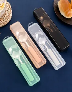 Close-up of four portable stainless steel cutlery sets with colorful cases on a dining scene