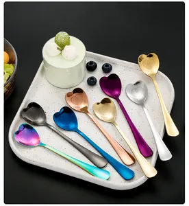 Macro view of heart-shaped stainless steel spoons with Happy Family engraving in 8 colors