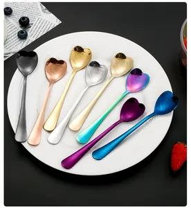 Macro detail of eight colorful heart-shaped stainless steel spoons with Happy Family engraving