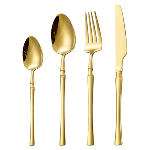 Polished gold stainless steel 4-piece cutlery set with slim handles on white background