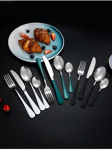 Macro detail of 1010 stainless steel cutlery set in white, green and black matte handles