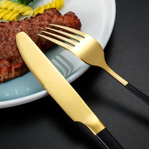 Modern 24-piece gold and matte black stainless steel cutlery set with steak knife and fork