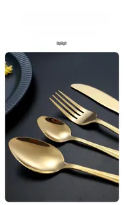 Close-up of golden stainless steel cutlery set with vertical striped texture handles